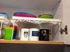 White stackers to increase storage space in the kitchen cabinet ...