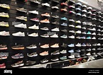 Shop display of a lot of Sports shoes on a wall. A view of a wall of ...