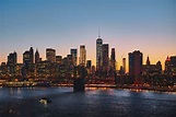 the new york city skyline and manhattan bridge at sunset, manhattan in ...