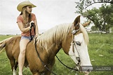 Young woman riding bareback on horse in ranch field, Bridger, Montana ...