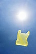 Yellow plastic bag in sky - Stock Photo - Dissolve