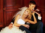 Drunk bride and groom sitting on floor - Stock Photo - Dissolve