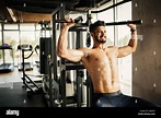 Bodybuilder working out in gym with determination Stock Photo - Alamy