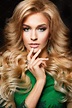 Portrait of elegant sexy blonde woman with long curly hair and glamour ...