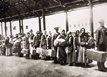 Immigrants at Ellis Island wait for the ferry to take them into New ...