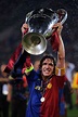 Carles Puyol of Barcelona lifts the trophy as he and his team mates ...