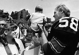Jack Lambert with a baby at Steelers training camp