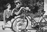 Barbara Hutton and husband, Cary Grant make adjustments to a bicycle ...