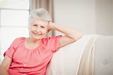 photodune-15042273-happy-senior-woman-sitting-on-sofa-in-living-room ...