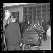 Actress Elsa Lanchester laying flowers on casket of her husband Charles ...