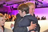 Actor John C. McGinley hugs his son Max after the fashion show.