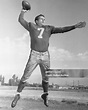 American football player Bob Waterfield prepares to throw a football ...