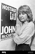 HARPENDEN - ENGLAND. Jill Morrell poses next to a poster of John ...