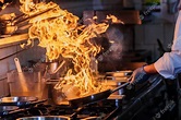 Premium Photo | Chef cooking in the kitchen, restaurant wok fire ...
