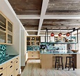 a kitchen with wooden cabinets and blue counter tops next to a dining ...