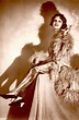 an old photo of a woman in a fur coat