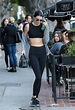 In a black crop top and leggings paired with a Givenchy handbag while ...