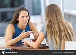 Two girls talking seriously in a coffee shop — Stock Photo ...