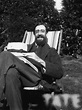 Photograph of Lytton Strachey, smiling, sitting in the garden at ...