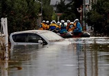 Rescuers search waist-high muddy waters for missing people in typhoon ...