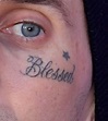 "Blessed" lettering tattoo on Travis Barker's face.