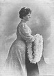 an old black and white photo of a woman in a long dress holding a fan