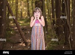 Lost little girl in the forest Stock Photo - Alamy