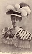 an old photo of a woman wearing a hat