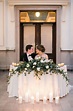 Bride and groom and their romantic sweetheart table. Greenery and white ...