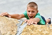 Child Athlete Falls Off a Cliff. Danger of Falling from a Hill. Climb a ...