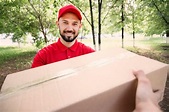 Portrait of young man delivering parcel | Free Photo