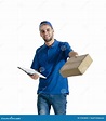 Young Handsome Courier Guy Making Delivery of Parcel Stock Photo ...
