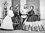 an old black and white photo of four people in long dresses standing ...