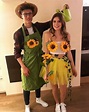 a man and woman dressed in costumes standing next to each other with ...