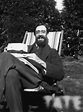 Photograph of Lytton Strachey, smiling, sitting in the garden at ...