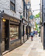 A historic lane in Richmond, London with lots of little shops. # ...