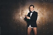 Men dressed in suit without pants opening champagne by Andrey Pavlov ...