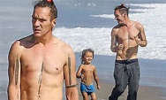 Jonathan Rhys Meyers goes shirtless for a run on the beach with son Wolf