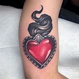 a woman's arm with a heart tattoo on it and a crown in the middle