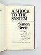 A SHOCK TO THE SYSTEM | Simon Brett | First Edition