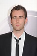 Suited and serious, Matthew Lewis attends the EA British Academy | An ...