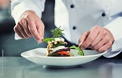 Chef in Restaurant garnishing vegetable dish Stock Photo | Adobe Stock