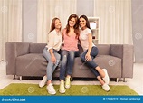 Three Happy Pretty Young Women Sitting on Couch Stock Photo - Image of ...