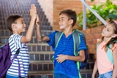 Premium Photo | School kids giving high five on staircase