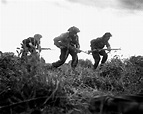 Three British infantrymen advance cautiously during a probe of German ...