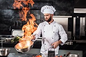 Chef cook food with fire at kitchen restaurant. Cook with wok at ...