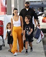 Kourtney Kardashian wears yellow pants while with her kids