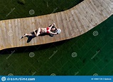 Drone Aerial View of Young Beauty Woman Sunbathing on the Sea Pier ...