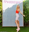Kate Bosworth shows fit figure in red tank top and tan biker shorts ...