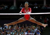 Gabrielle Douglas of the U.S. performs on the asymmetric bars during ...